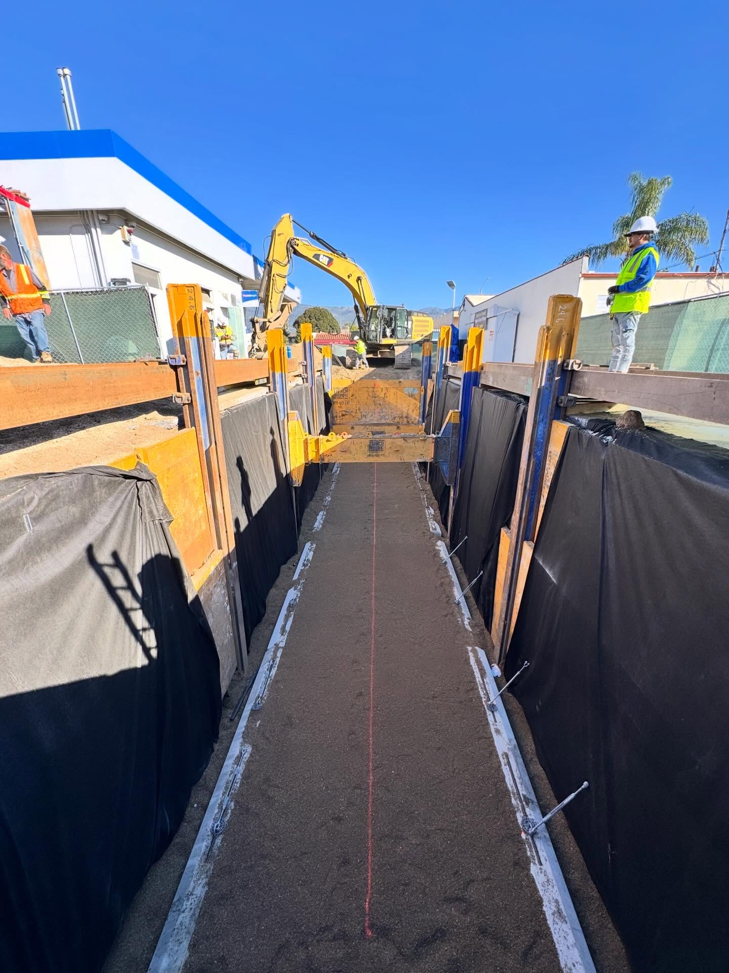 Prepared tank excavation with shoring and site equipment